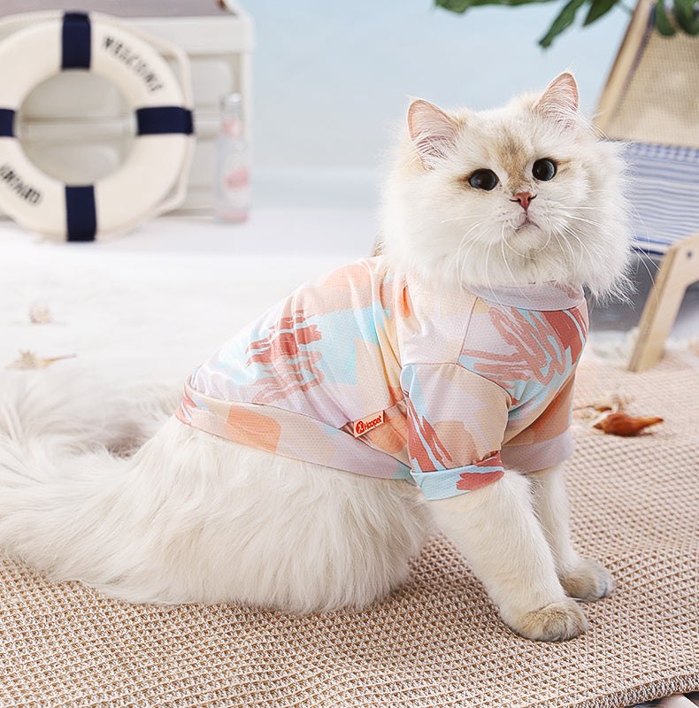 Cat wearing a colorful summer vest designed for preventing hair loss.