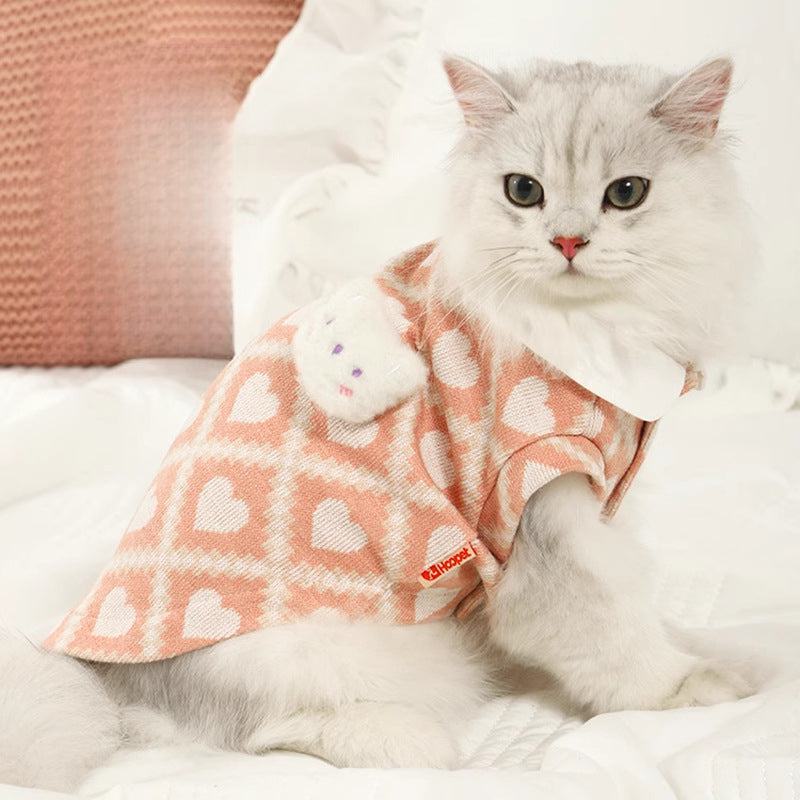 Cat wearing anti-shedding clothes with a heart pattern, ideal for spring and autumn.