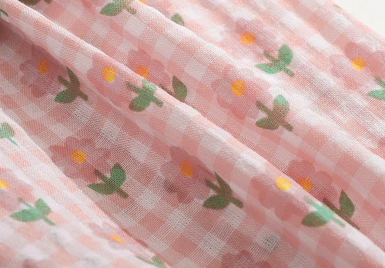 Lightweight pink fabric with floral and checkered pattern for summer kitten vest.