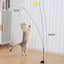 Cat playing with steel wire teaser feather toy on long pole with suction cup for self-amusement.