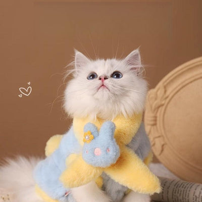 Adorable cat wearing warm winter vest outfit with bunny design.