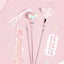 Cat teaser wand toy with feathers and bells on a pink background.