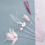 Cat teaser wand toy with feathers and bells for pet entertainment.
