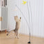 Cat playing with a steel wire teaser featuring a feathered toy, supported by a suction cup base for self-amusement.